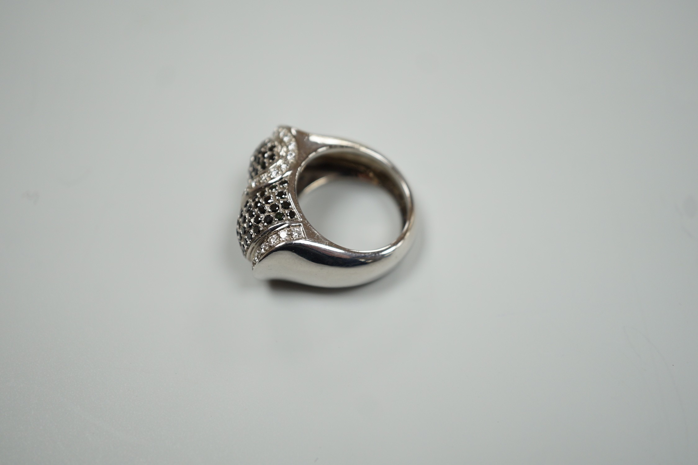 A modern 750 white metal and pave set two colour diamond dress ring, size K/L, gross weight 15.4 grams.